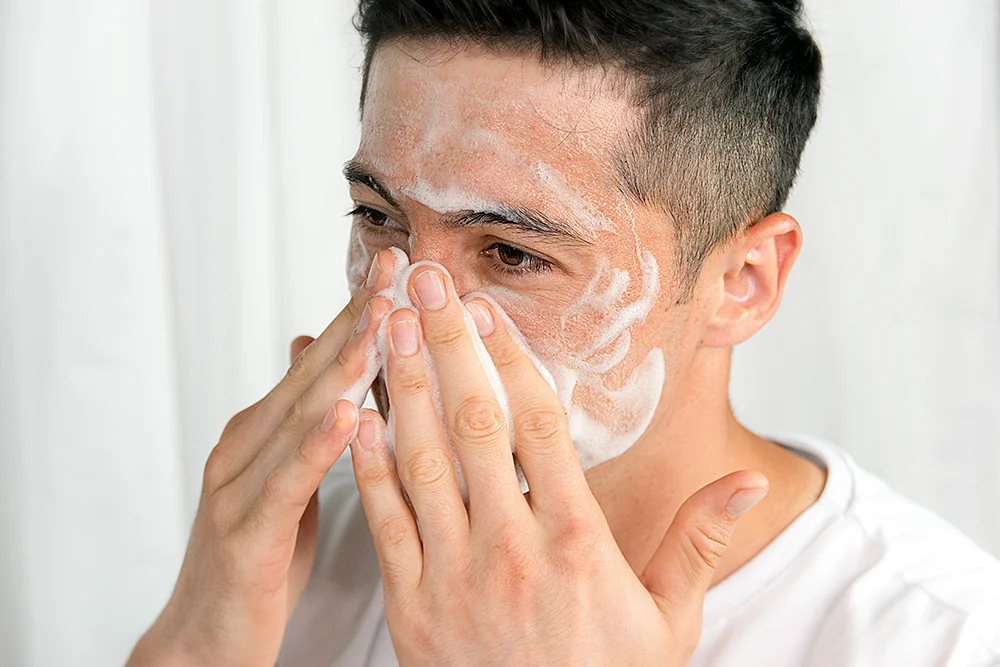 A man does his skincare routine