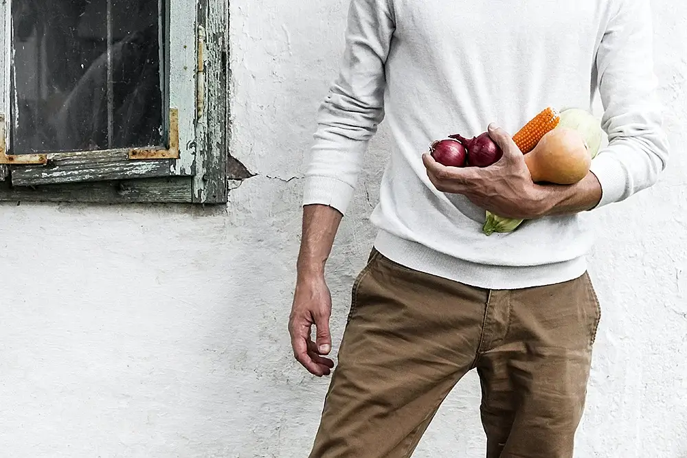 A man holding healthy vegetables