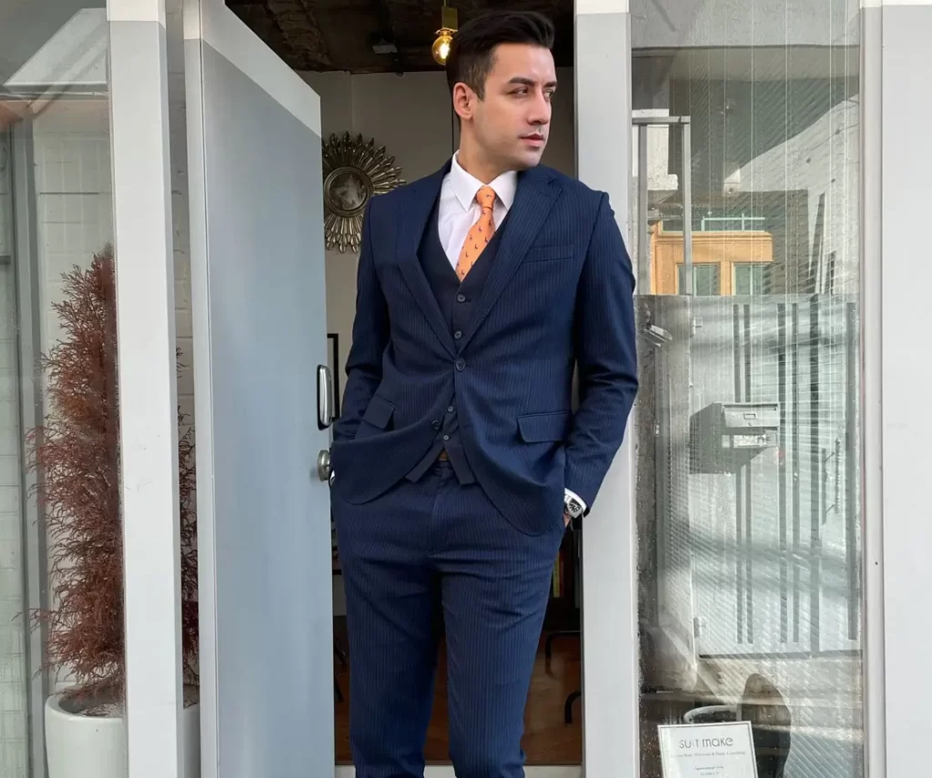 A man wearing a blue suit for the Lunar New Year