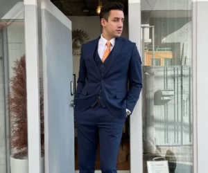 A man wearing a blue suit for the Lunar New Year