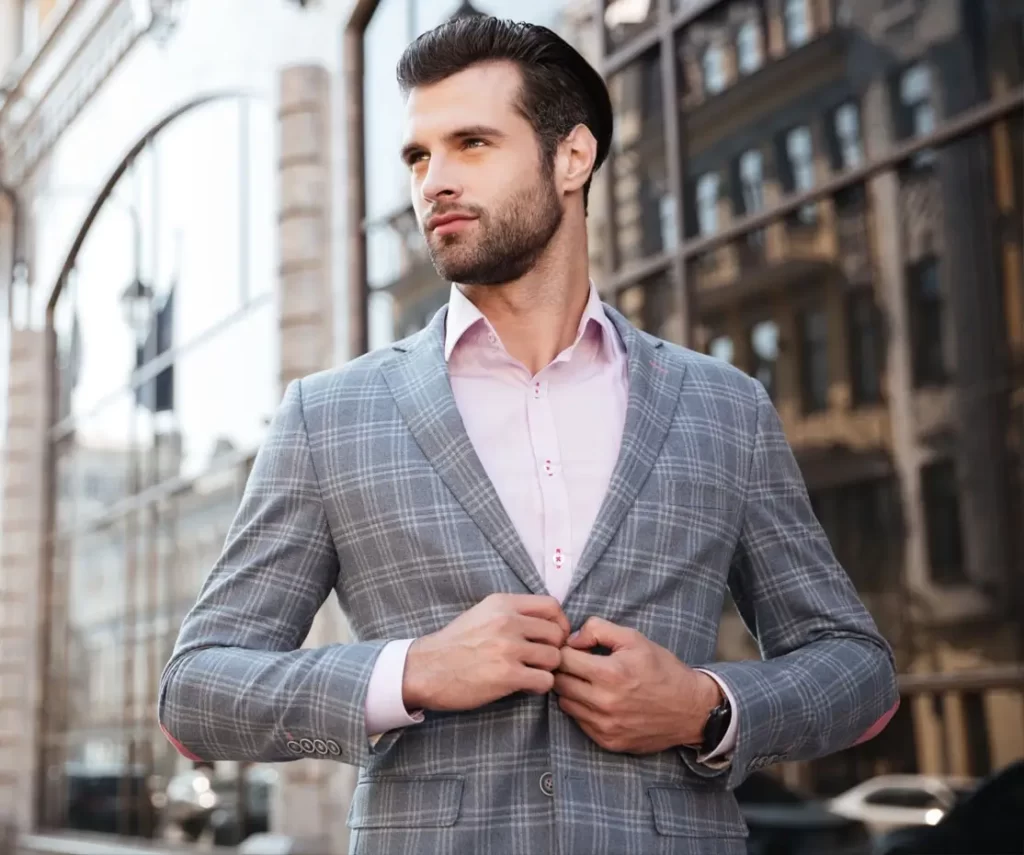 A man wearing a thin blazer over a shirt for a spring date outfit