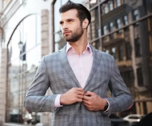 A man wearing a thin blazer over a shirt for a spring date outfit